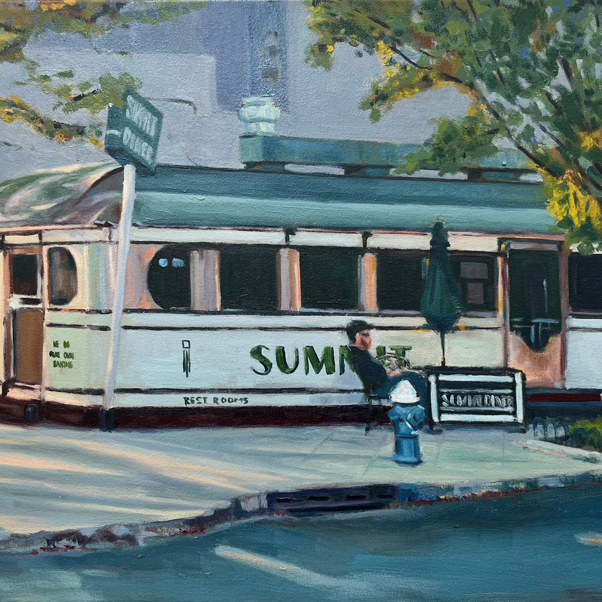 Summit Diner by Manuel Monge. A man sits in front of the Summit Diner in Summit, NJ. The surroundings are filled with trees, signs, pavement, and roads.