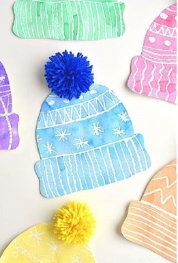 There is a rainbow of winter hats, with the picture focusing on the blue one. They are mixed media, the "knitted" part of the hat being made using watercolor and the pompom being made using yarn.